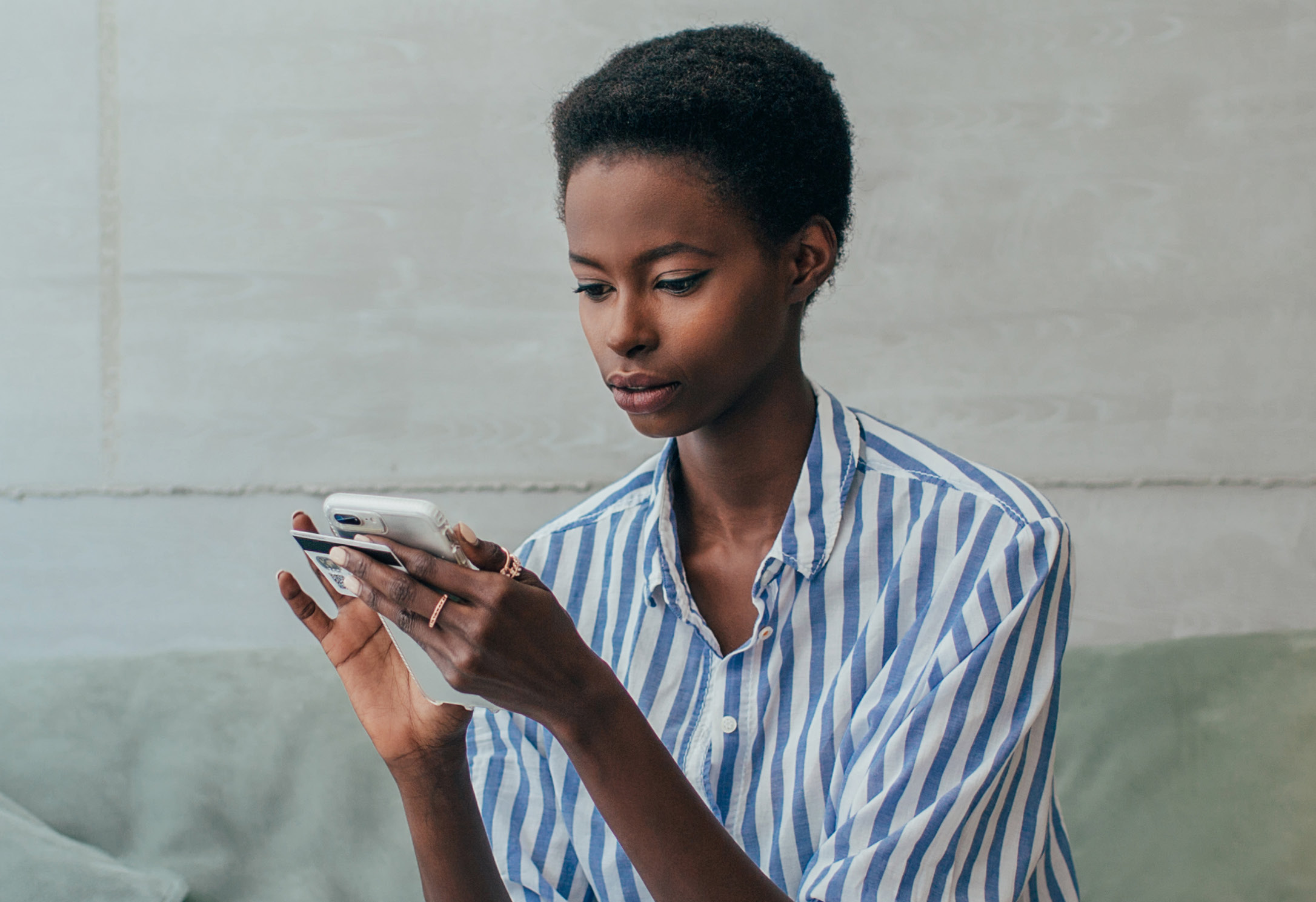 women with credit card on phone